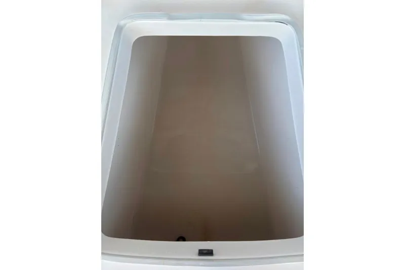 Slide: The Image of Storage compartment of a 2014 Robalo 206 Cayman boat, featuring a clean, spacious interior. - 18