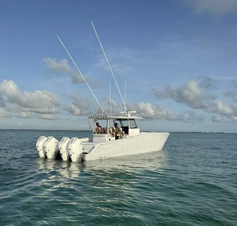 The Image of 2026 Freeman 38 boat with multiple engines on calm ocean waters. - 0