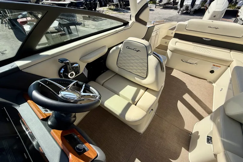 Slide: The Image of Interior of 2026 Chris-Craft Sportster 28 OB, featuring luxurious seating and modern steering wheel. - 4