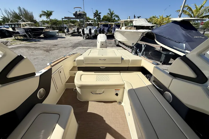 Slide: The Image of 2026 Chris-Craft Sportster 28 OB interior with beige seating, docked among other boats. - 3