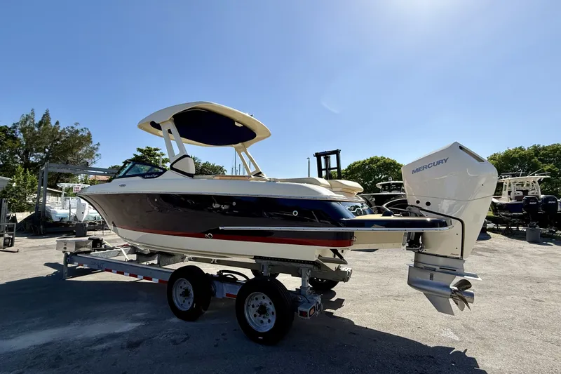 The Image of 2026 Chris-Craft Sportster 28 OB boat on trailer, featuring Mercury outboard engine. - 1