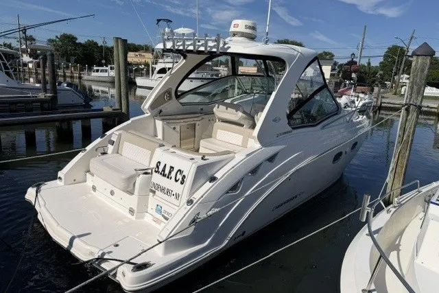 The Image of 2015 Chaparral 310 Signature boat docked at marina, featuring sleek design and spacious seating. - 0