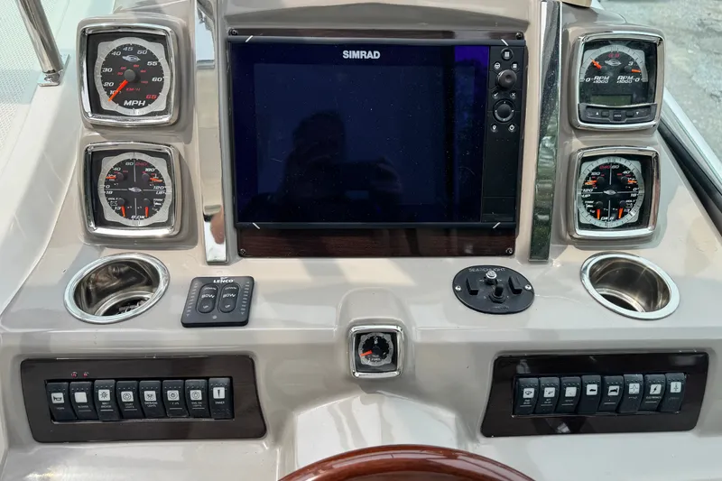 Slide: The Image of Control panel of a 2015 Chaparral 310 Signature boat with gauges and navigation display. - 8