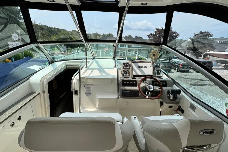 Slide: The Image of Interior view of 2015 Chaparral 310 Signature boat cockpit with steering wheel and navigation system. - 6