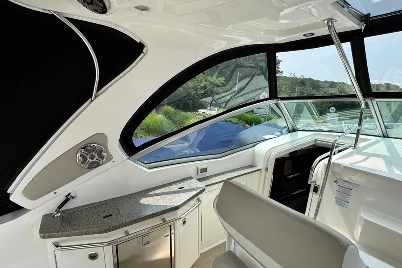 Slide: The Image of Interior view of 2015 Chaparral 310 Signature boat, featuring sleek design and modern amenities. - 10