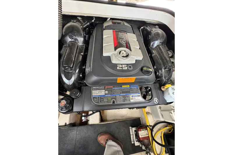 Slide: The Image of Engine compartment of a 2015 Chaparral 310 Signature boat featuring a Mercury 4.5L 250 engine. - 28