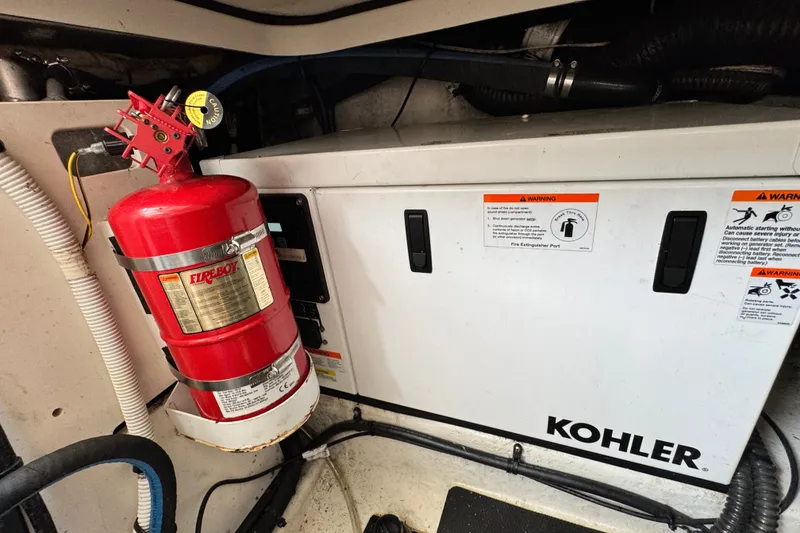 Slide: The Image of Engine room of 2015 Chaparral 310 Signature with Kohler generator and Fireboy extinguisher. - 29