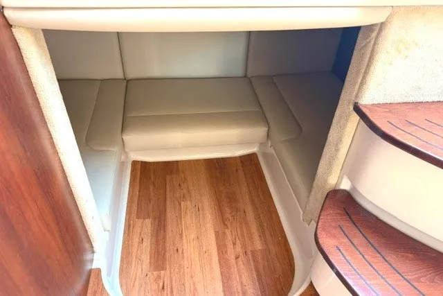 Slide: The Image of 2015 Chaparral 310 Signature cabin interior with wood flooring and cushioned seating. - 20