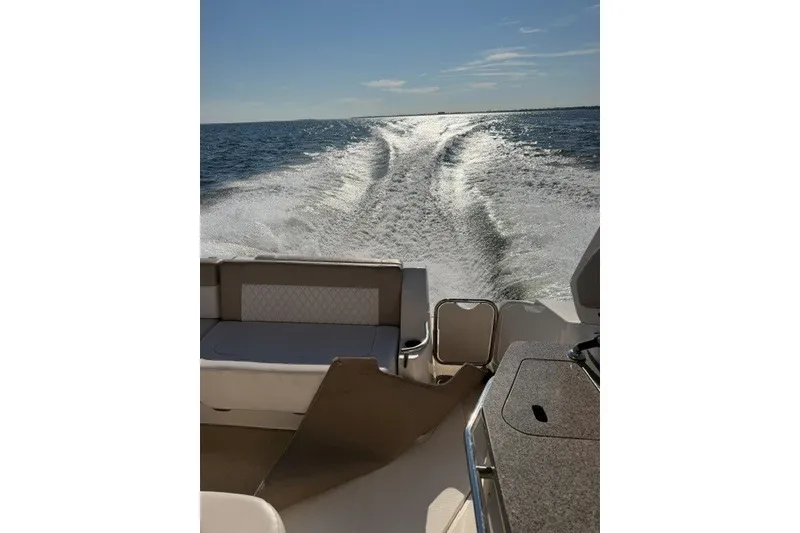 Slide: The Image of 2015 Chaparral 310 Signature cruising on open water, leaving a wake behind. - 36