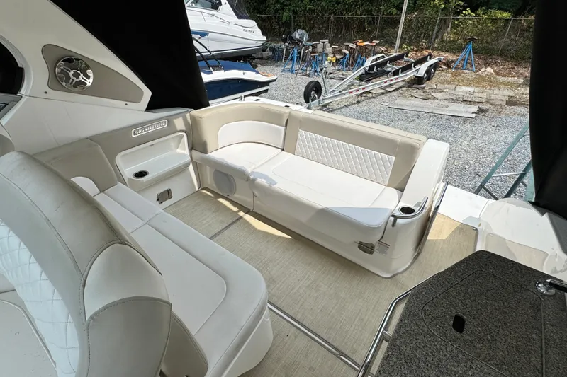 Slide: The Image of Interior of 2015 Chaparral 310 Signature boat with white seating and modern design. - 13