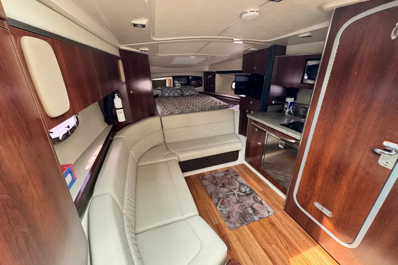 Slide: The Image of Luxurious interior of 2015 Chaparral 310 Signature boat with wood accents and cozy seating. - 15