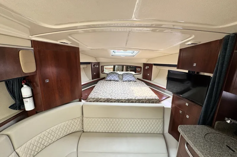 Slide: The Image of Luxurious interior of 2015 Chaparral 310 Signature boat with cozy bed and modern amenities. - 17