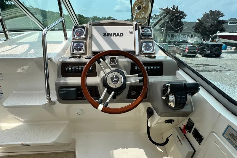 Slide: The Image of Cockpit of 2015 Chaparral 310 Signature boat with steering wheel and control panel. - 7