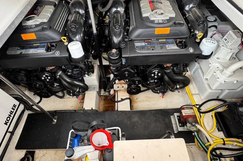 Slide: The Image of Engine compartment of a 2015 Chaparral 310 Signature boat, featuring dual Mercury 4.5L engines. - 27