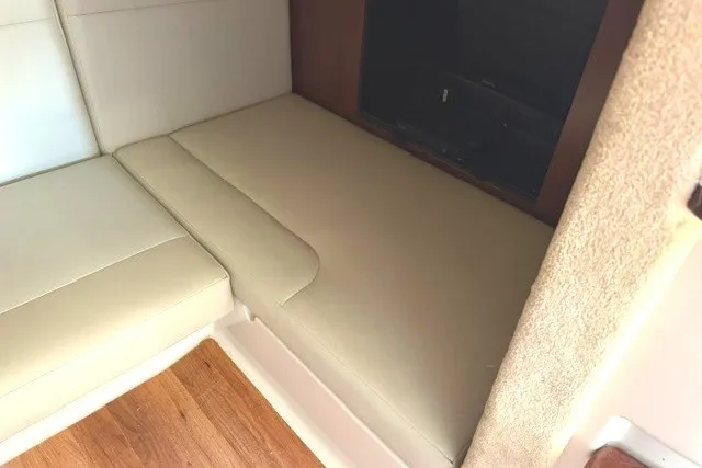 Slide: The Image of Interior seating area of 2015 Chaparral 310 Signature boat with beige upholstery. - 22