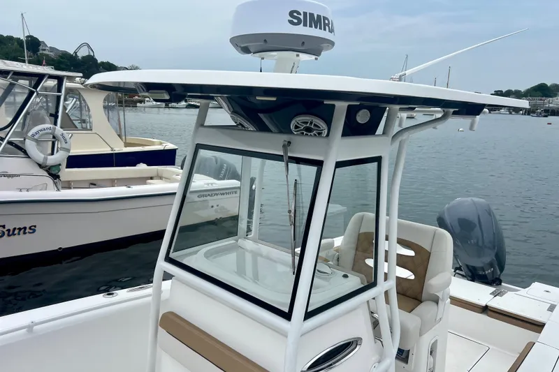 Slide: The Image of 2021 Release 240 RX boat with Simrad radar, docked in a marina. - 14