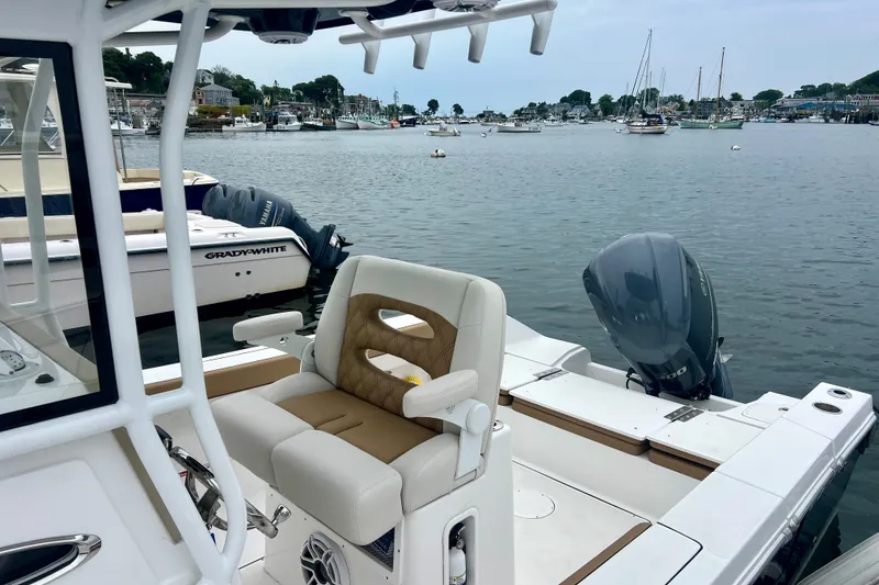 Slide: The Image of 2021 Release 240 RX boat with Yamaha engine docked in a scenic marina. - 9