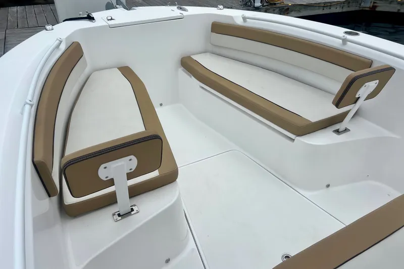 Slide: The Image of 2021 Release 240 RX boat interior with tan and white cushioned seating. - 18