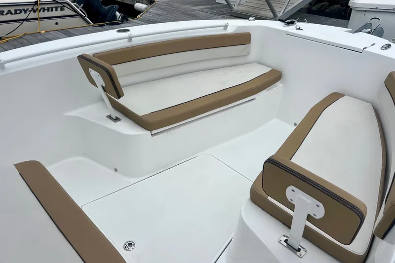 Slide: The Image of 2021 Release 240 RX boat interior with tan and white seating. - 17
