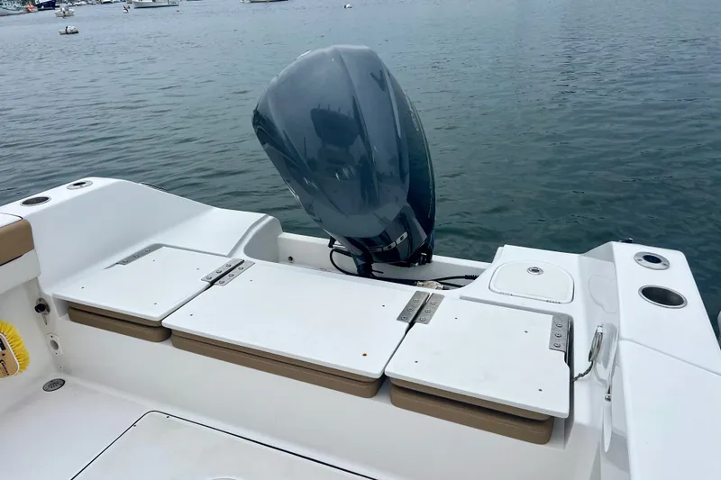 Slide: The Image of 2021 Release 240 RX boat with outboard motor on calm water. - 5