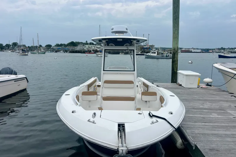 Slide: The Image of 2021 Release 240 RX boat docked at a marina with scenic harbor view. - 3