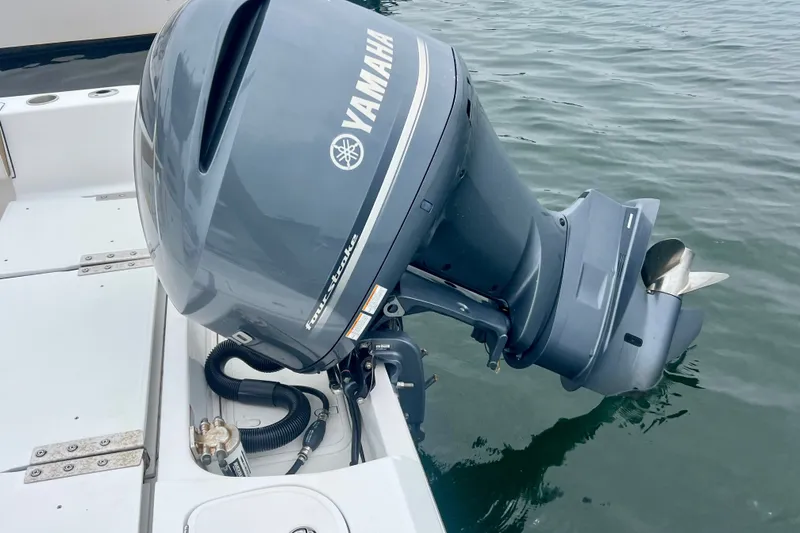 Slide: The Image of Yamaha four-stroke outboard motor on 2021 Release 240 RX boat in water. - 6