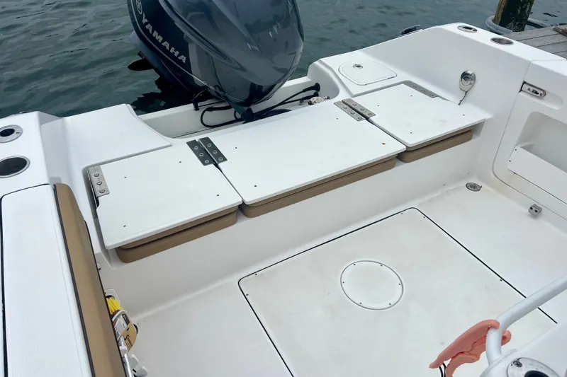 Slide: The Image of 2021 Release 240 RX boat interior with Yamaha engine, featuring white seating and storage compartments. - 8