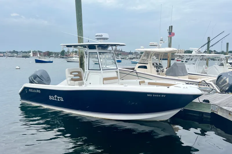 Slide: The Image of 2021 Release 240 RX boat docked in a marina, featuring a sleek design and Yamaha engine. - 1