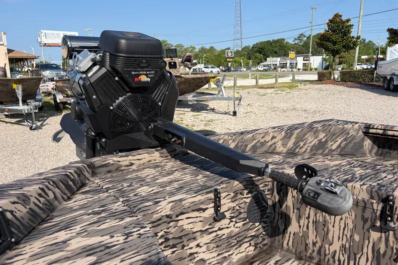 Slide: The Image of Camouflage-patterned 2026 Havoc 1756 MSTC boat with powerful outboard motor in a dealership lot. - 7