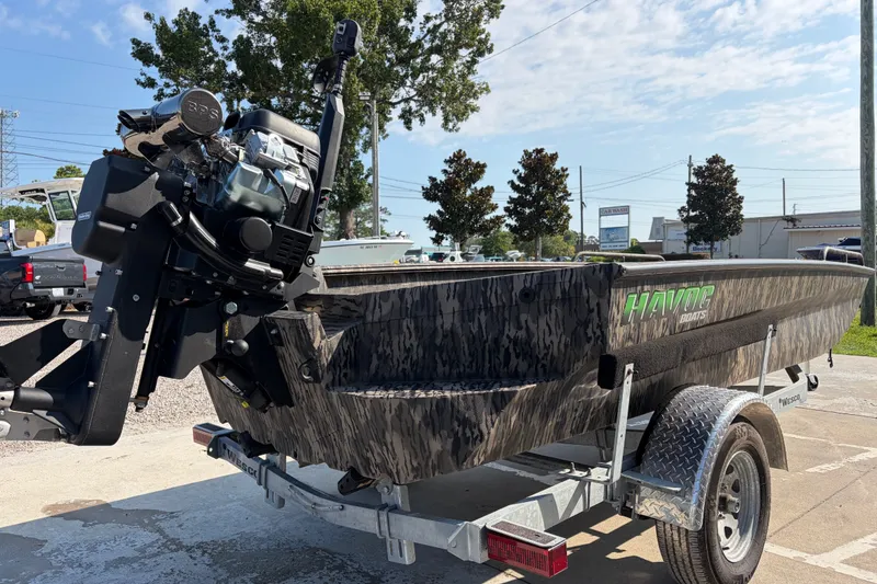 Slide: The Image of 2026 Havoc 1756 MSTC boat on trailer, featuring camo design and powerful outboard motor. - 4