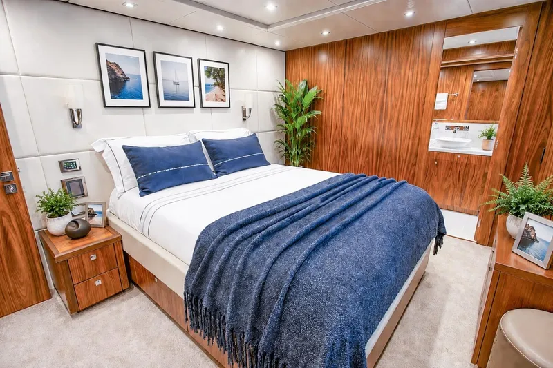 Slide: The Image of Luxurious bedroom interior on 2014 Sunseeker 131 Yacht with elegant wood paneling. - 34