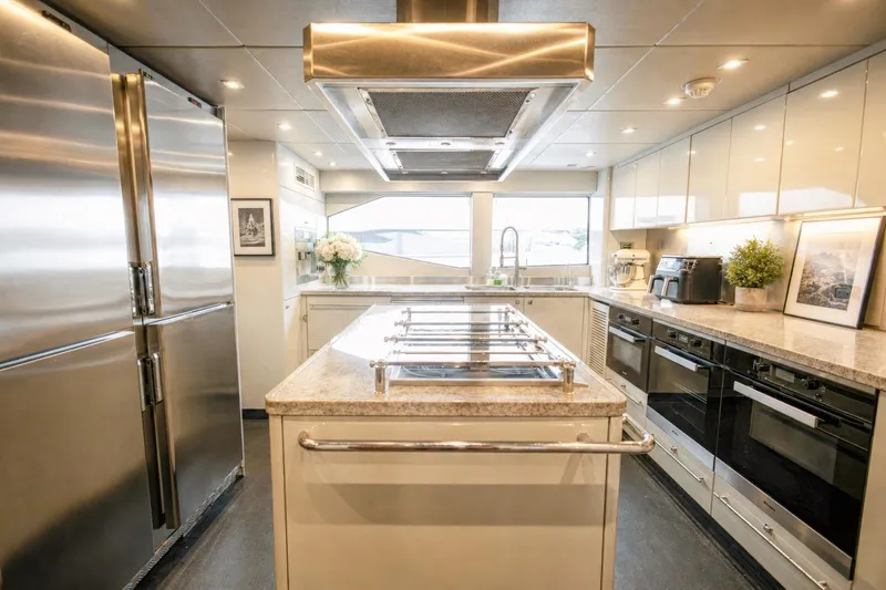 Slide: The Image of Luxurious kitchen interior on a 2014 Sunseeker 131 Yacht, featuring modern appliances and elegant design. - 47