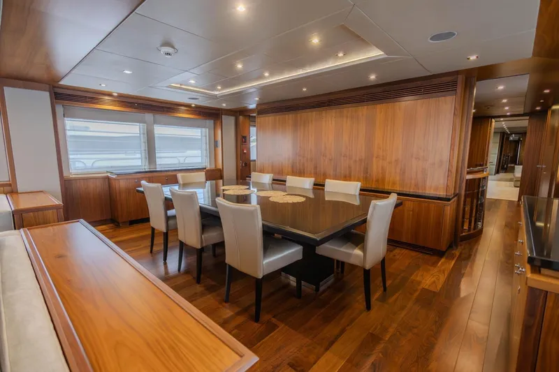 Slide: The Image of Luxurious dining area on a 2014 Sunseeker 131 Yacht, featuring elegant wood paneling and modern furnishings. - 48