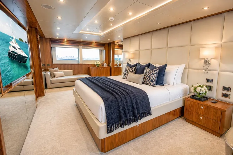 Slide: The Image of Luxurious bedroom interior on 2014 Sunseeker 131 Yacht, featuring elegant decor and plush bedding. - 13