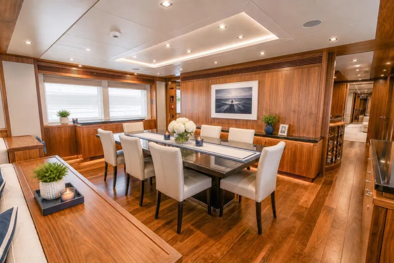 Slide: The Image of Luxurious dining area on a 2014 Sunseeker 131 Yacht, featuring elegant wood finishes and modern decor. - 6