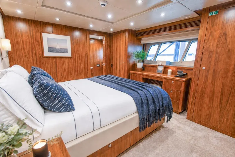 Slide: The Image of Luxurious Sunseeker 131 Yacht 2014 bedroom with elegant wood paneling and cozy decor. - 41