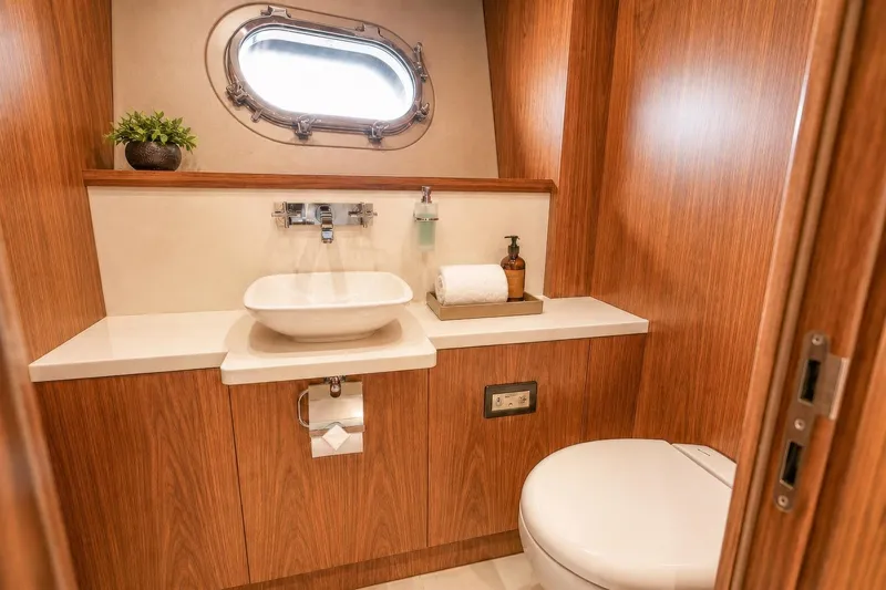 Slide: The Image of Luxurious bathroom on 2014 Sunseeker 131 Yacht with wood paneling and modern fixtures. - 21