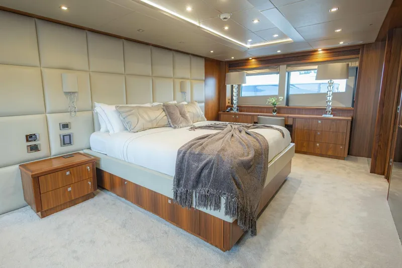 Slide: The Image of Luxurious bedroom interior on a 2014 Sunseeker 131 Yacht, featuring elegant wood finishes and plush bedding. - 52