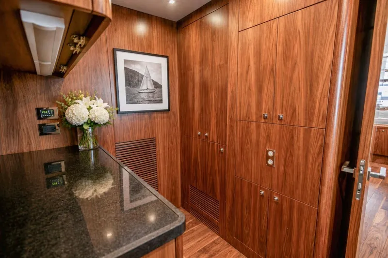 Slide: The Image of Luxurious wood-paneled interior of 2014 Sunseeker 131 Yacht with elegant decor and floral arrangement. - 50