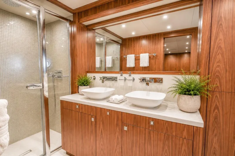 Slide: The Image of Luxurious bathroom on 2014 Sunseeker 131 Yacht with dual sinks and elegant wood finish. - 35