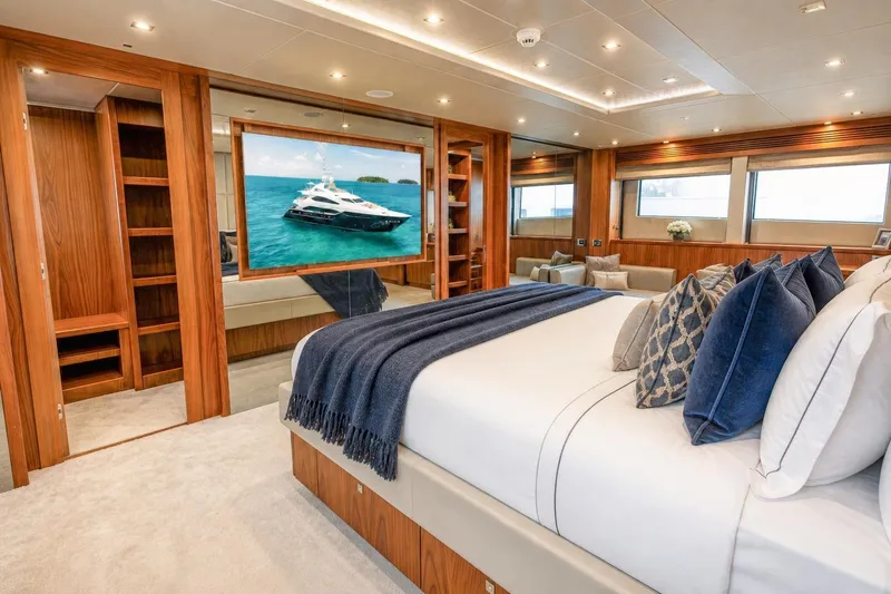 Slide: The Image of Luxurious Sunseeker 131 Yacht 2014 bedroom with elegant wood finishes and plush bedding. - 14
