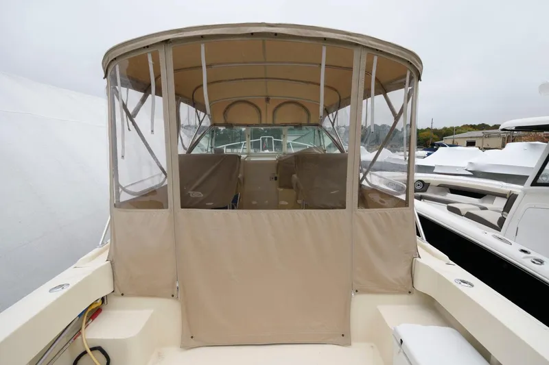 Slide: The Image of The 2001 Mainship Pilot 30 features a covered cockpit with clear side panels. - 12