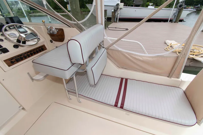 Slide: The Image of 2001 Mainship Pilot 30 boat interior with steering wheel and cushioned seating. - 6