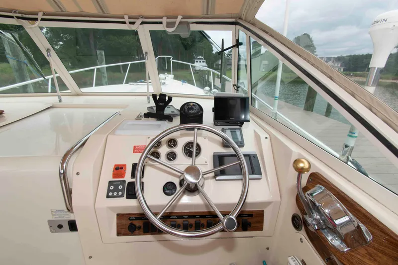 Slide: The Image of 2001 Mainship Pilot 30 helm with steering wheel, gauges, and navigation equipment. - 9