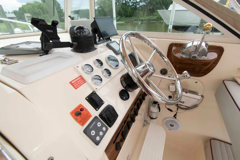 Slide: The Image of 2001 Mainship Pilot 30 helm with steering wheel, gauges, and navigation equipment. - 11