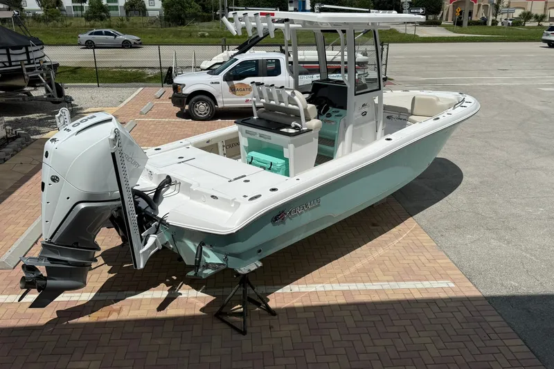 Slide: The Image of 2027 Crevalle 24 HCO boat with outboard motor on display in a parking lot. - 3