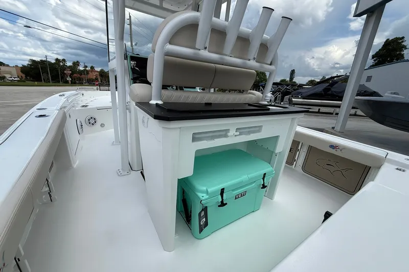 Slide: The Image of 2027 Crevalle 24 HCO boat interior with Yeti cooler and rod holders. - 9
