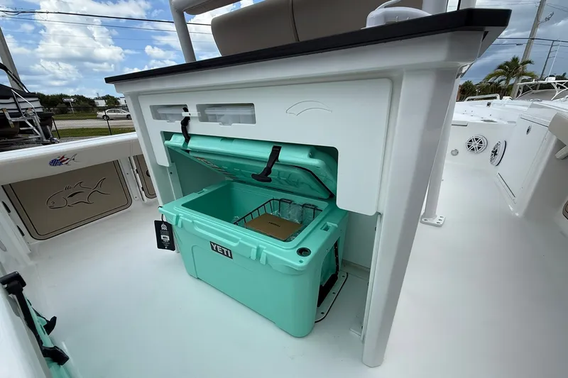 Slide: The Image of Crevalle 24 HCO 2027 boat with open Yeti cooler on deck. - 10