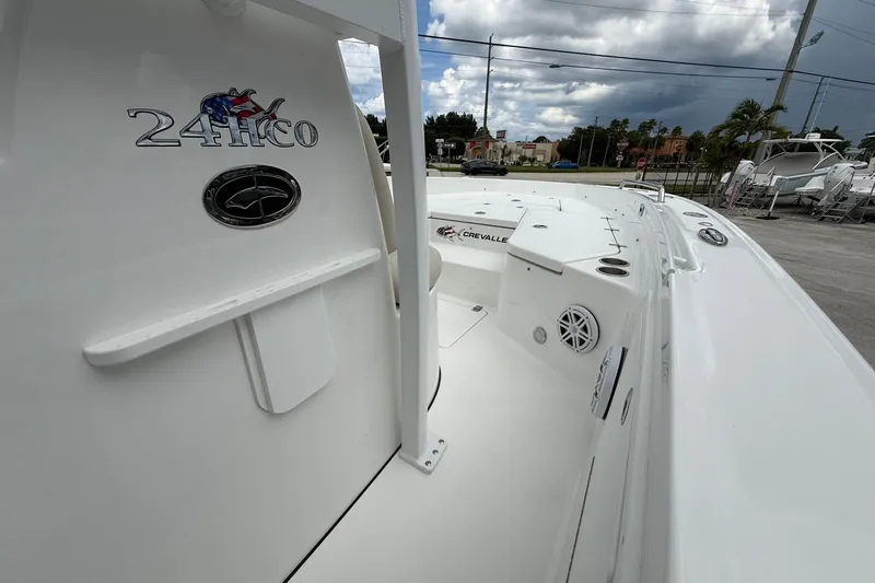 Slide: The Image of 2027 Crevalle 24 HCO boat, sleek white design, docked under cloudy sky. - 20