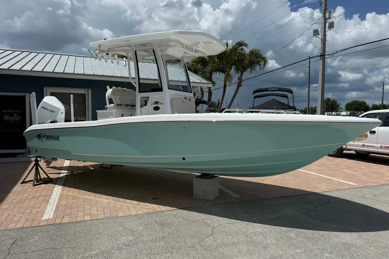 Slide: The Image of 2027 Crevalle 24 HCO boat displayed outdoors under cloudy sky. - 1